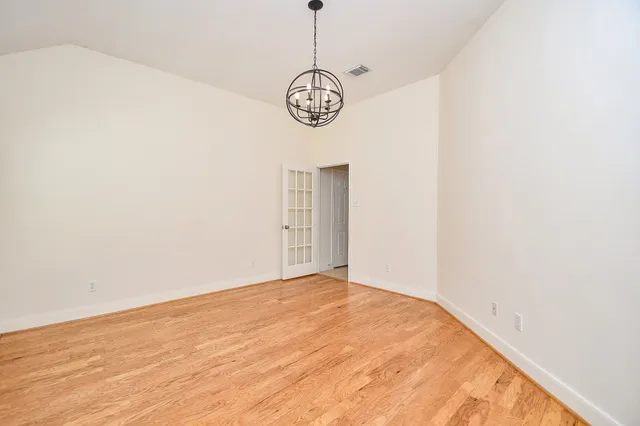 a view of a room with wooden floor and white walls