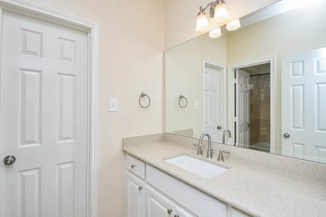 a bathroom with a sink vanity and a mirror