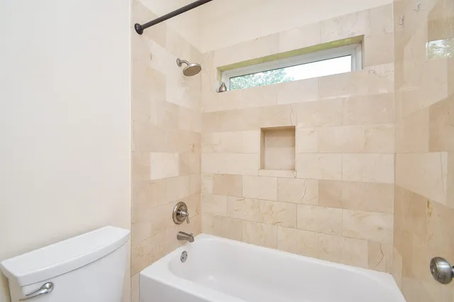 a bathroom with a bathtub and shower
