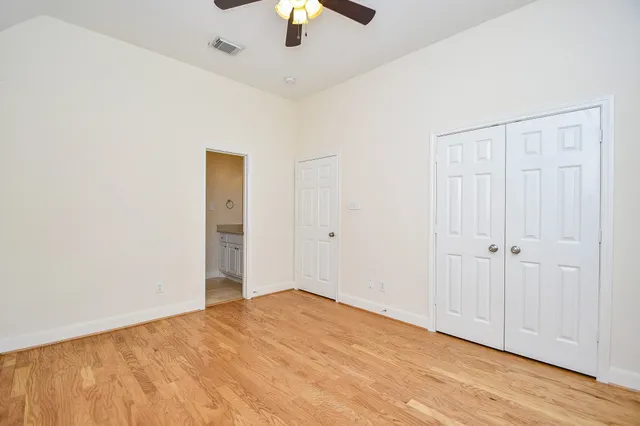a view of empty room with wooden floor