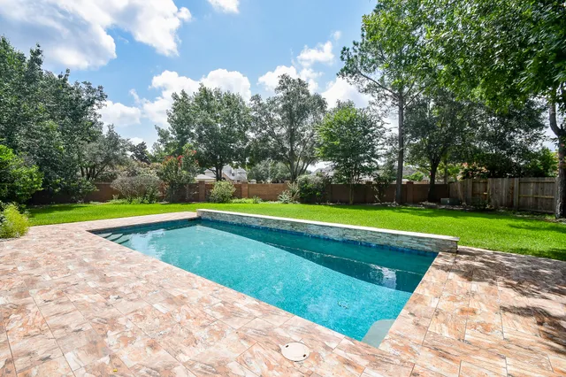 a view of swimming pool with a yard