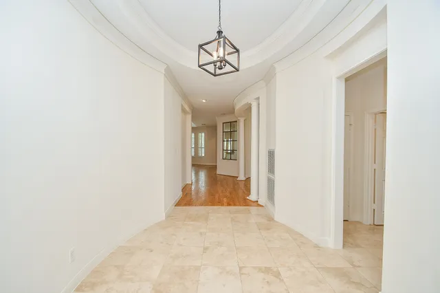 a view of hallway with chandelier