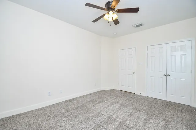 a view of a big room with carpet