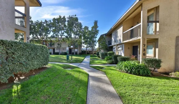 a view of a brick building next to a yard