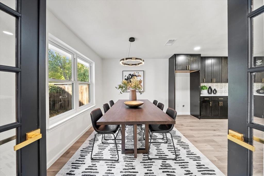 3609 Hidalgo Street Irving, TX 75062 - Photo 13 of 40 a view of a dining room with furniture a chandelier and wooden floor