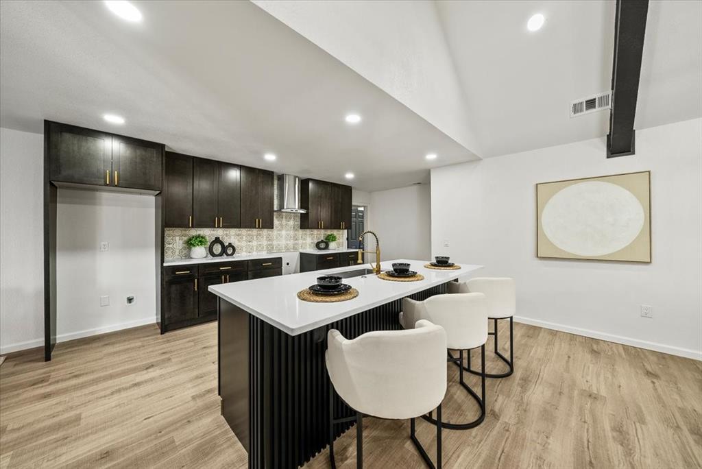 3609 Hidalgo Street Irving, TX 75062 - Photo 15 of 40 a kitchen with a sink a refrigerator a stove and chairs with wooden floor