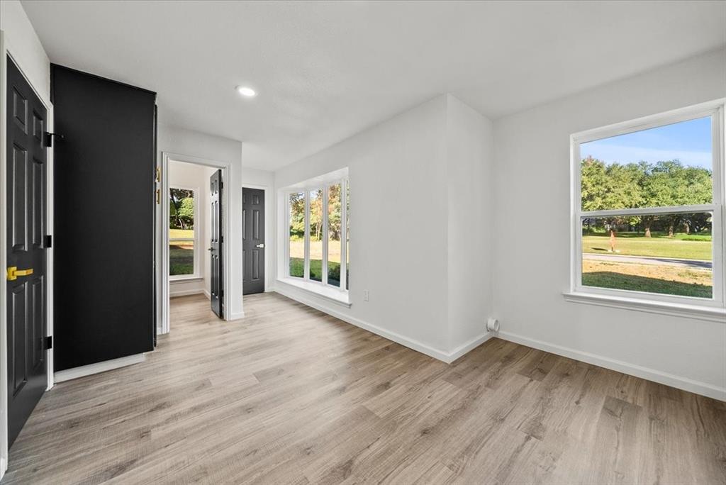 3609 Hidalgo Street Irving, TX 75062 - Photo 27 of 40 a view of an empty room with wooden floor and a window