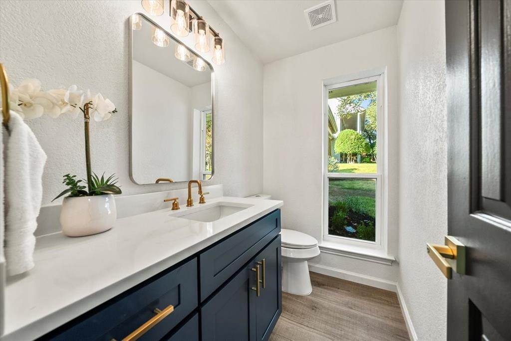 3609 Hidalgo Street Irving, TX 75062 - Photo 28 of 40 a bathroom with a sink a toilet and a mirror