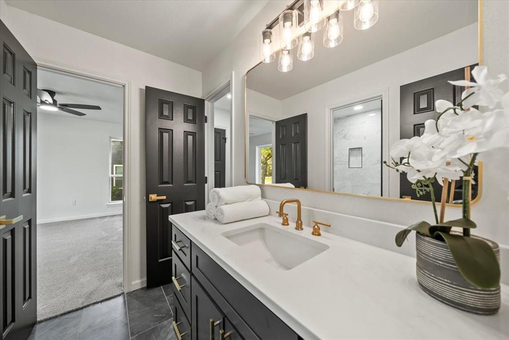 3609 Hidalgo Street Irving, TX 75062 - Photo 33 of 40 a spacious bathroom with a double vanity sink shower and a mirror