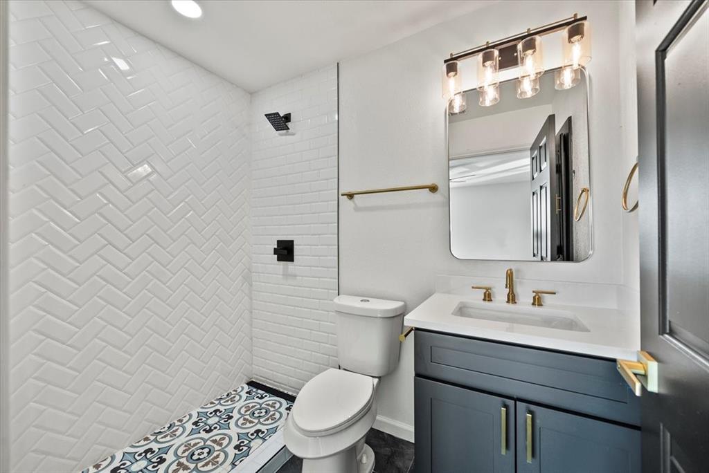 3609 Hidalgo Street Irving, TX 75062 - Photo 35 of 40 a bathroom with a granite countertop toilet sink and a mirror