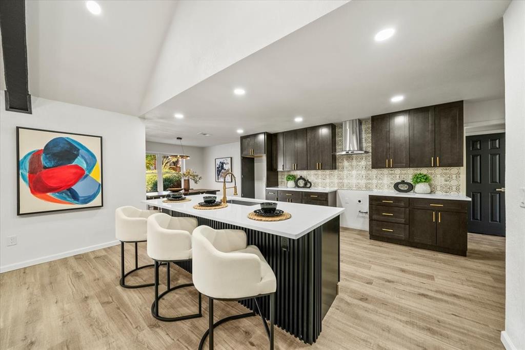 3609 Hidalgo Street Irving, TX 75062 - Photo 9 of 40 a kitchen with stainless steel appliances kitchen island granite countertop a kitchen island a stove a sink a dining table and chairs