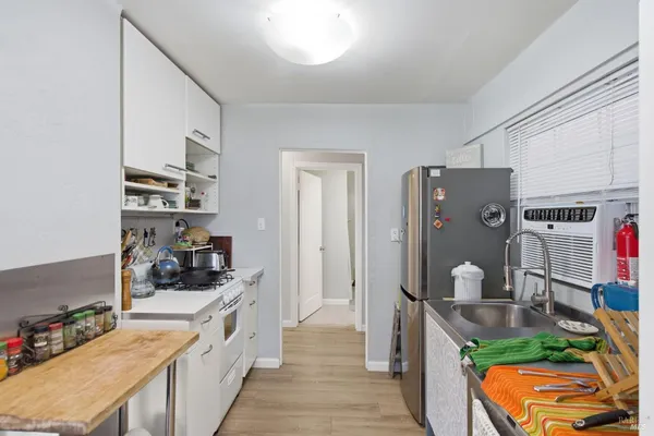 a kitchen with stainless steel appliances granite countertop a refrigerator and a stove