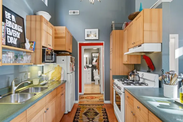 a kitchen with a sink stove and cabinets