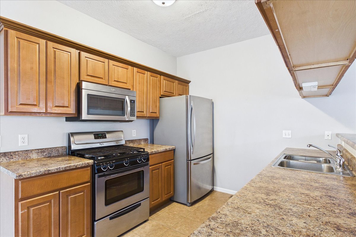 607 Clayton Circle, Unit 607 Sycamore, IL 60178 - Photo 11 of 48 a kitchen with stainless steel appliances granite countertop a stove a refrigerator and a microwave