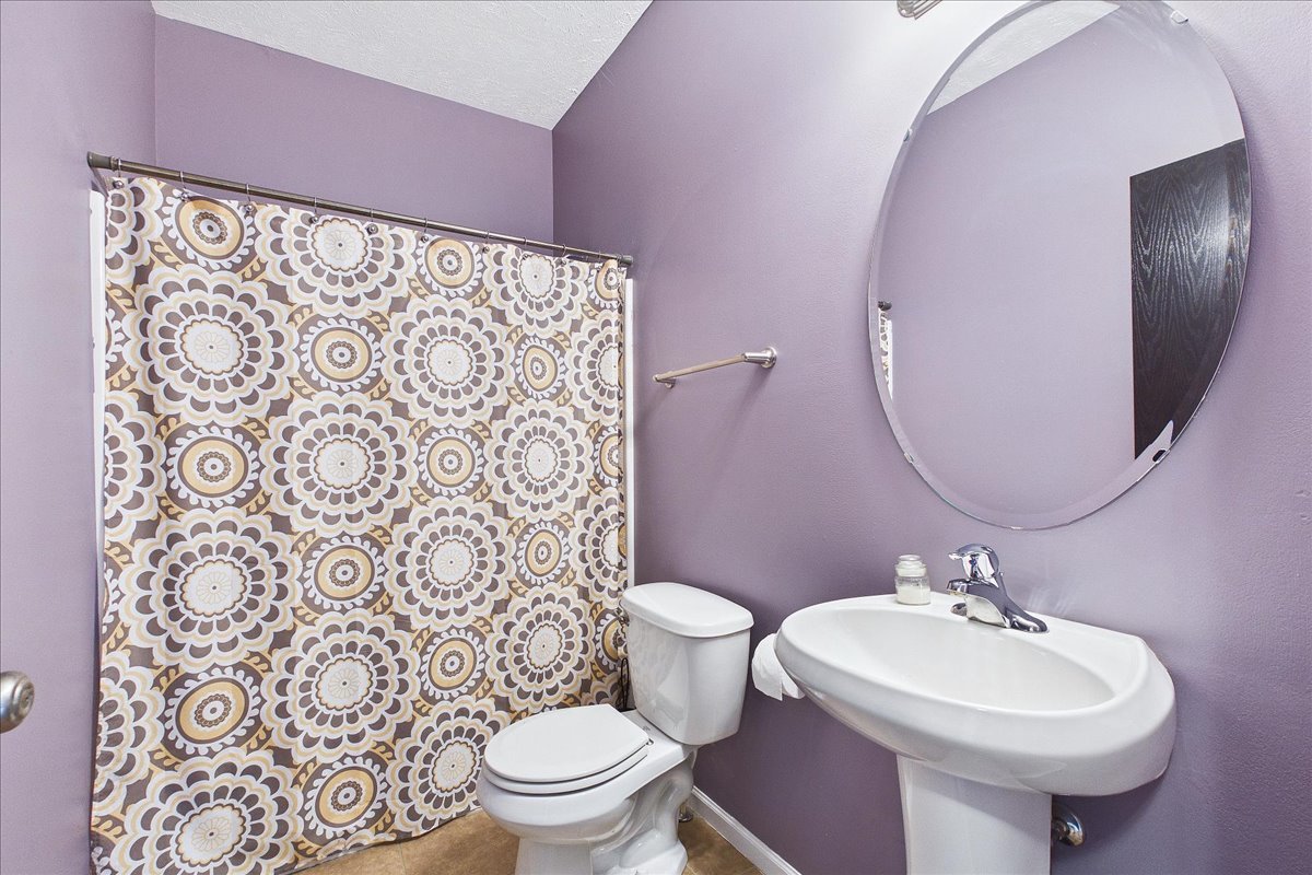 607 Clayton Circle, Unit 607 Sycamore, IL 60178 - Photo 13 of 48 a bathroom with a sink toilet and mirror