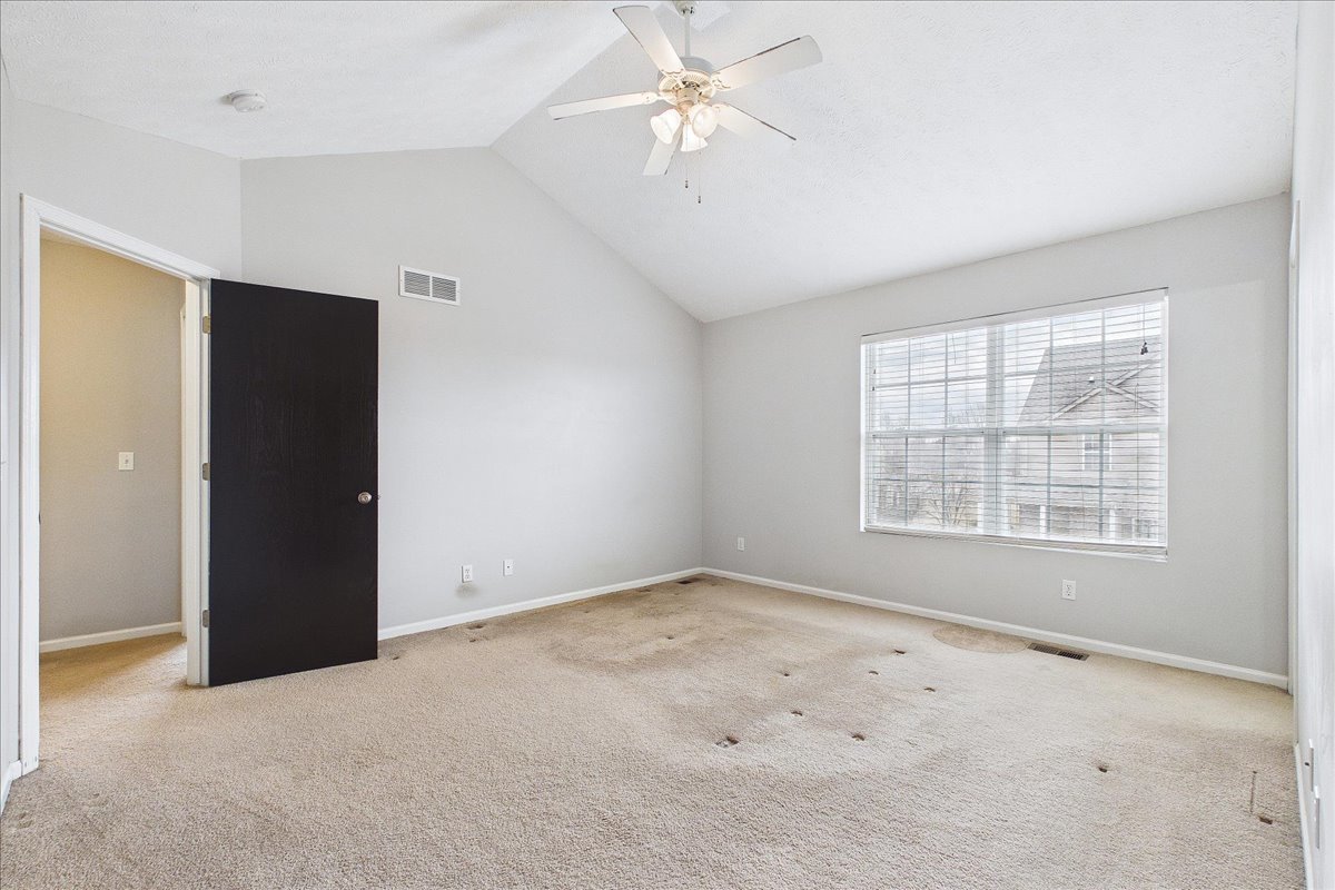 607 Clayton Circle, Unit 607 Sycamore, IL 60178 - Photo 16 of 48 an empty room with chandelier fan and windows