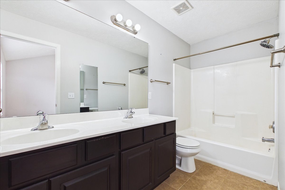 607 Clayton Circle, Unit 607 Sycamore, IL 60178 - Photo 17 of 48 a bathroom with a double vanity sink toilet mirror and bathtub