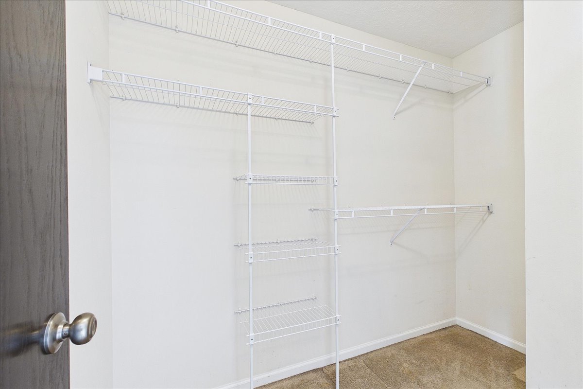 607 Clayton Circle, Unit 607 Sycamore, IL 60178 - Photo 18 of 48 a view of walk in closet with empty racks