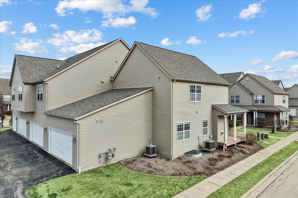 607 Clayton Circle, Unit 607 Sycamore, IL 60178 - Photo 2 of 48 a view of house with yard
