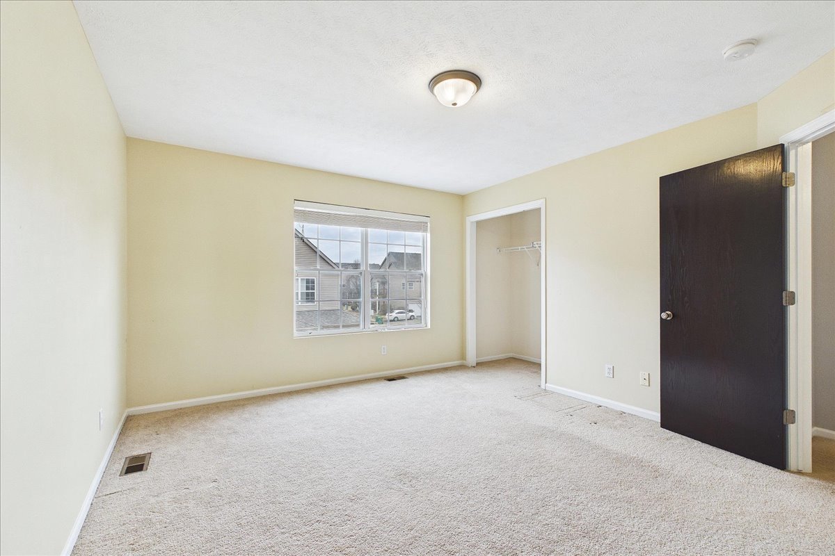 607 Clayton Circle, Unit 607 Sycamore, IL 60178 - Photo 21 of 48 a view of an empty room with a window