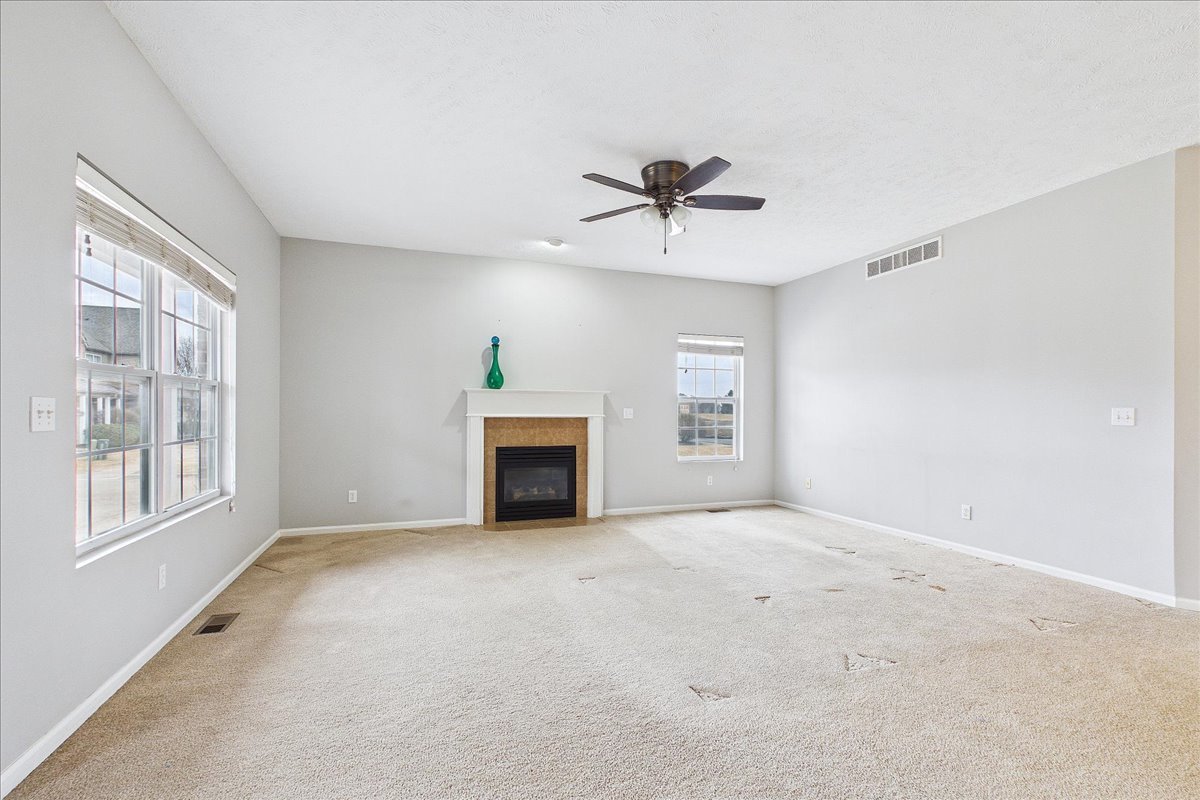 607 Clayton Circle, Unit 607 Sycamore, IL 60178 - Photo 3 of 48 a view of an empty room with a fireplace and a window