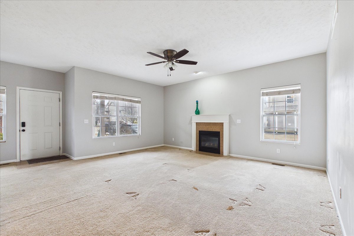607 Clayton Circle, Unit 607 Sycamore, IL 60178 - Photo 4 of 48 an empty room with windows and fireplace