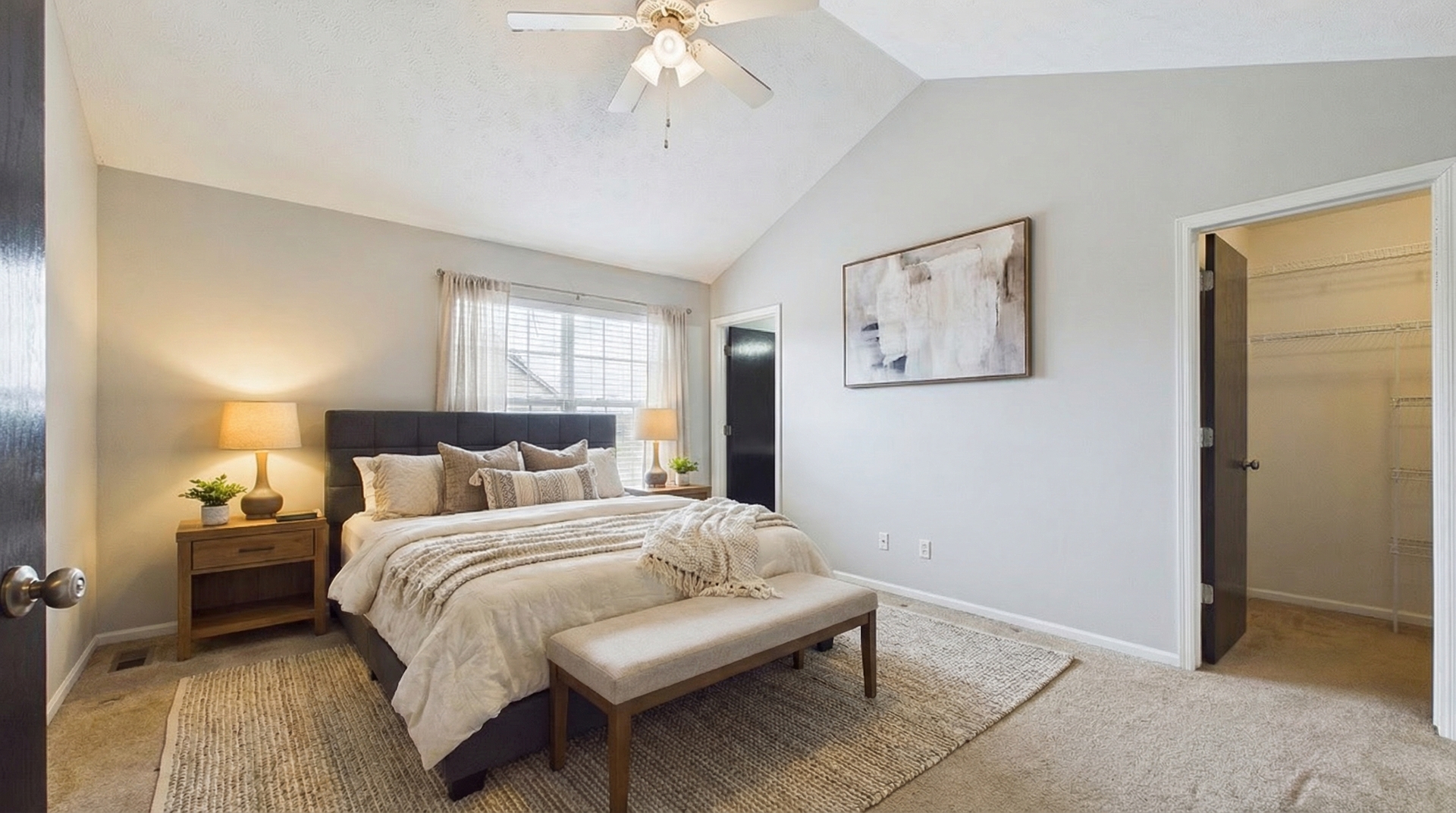 607 Clayton Circle, Unit 607 Sycamore, IL 60178 - Photo 42 of 48 a bedroom with a large bed and a chandelier