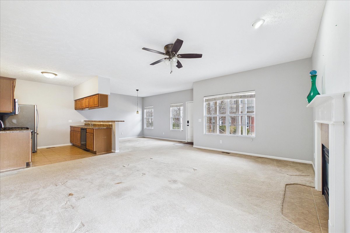 607 Clayton Circle, Unit 607 Sycamore, IL 60178 - Photo 5 of 48 a view of an empty room with a window and kitchen view