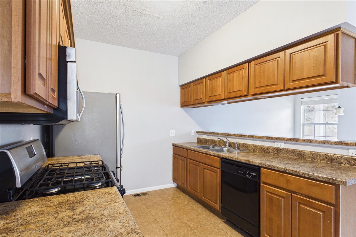 607 Clayton Circle, Unit 607 Sycamore, IL 60178 - Photo 10 of 48 a kitchen with stainless steel appliances granite countertop a stove a sink and a microwave