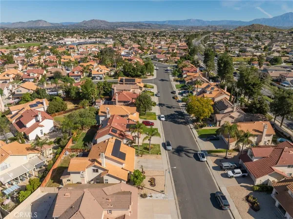 an aerial view of a house with a yard
