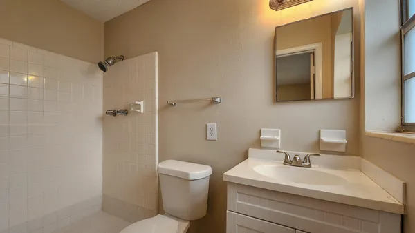 a bathroom with a toilet sink and shower