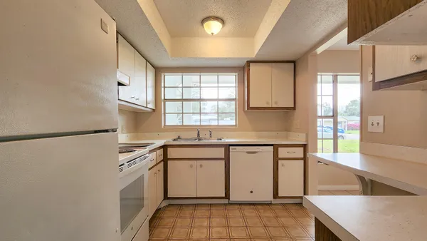 a kitchen with a sink stove and refrigerator