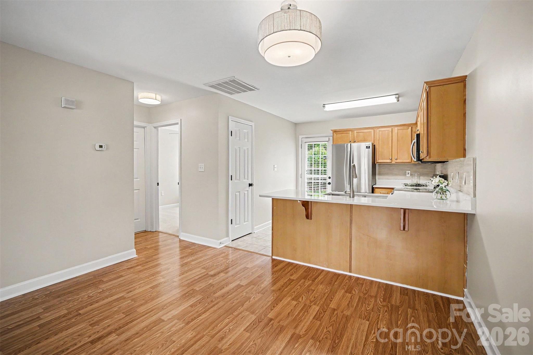 1210 Sheldon Brook Lane Fort Mill, SC 29707 - Photo 11 of 26 a view of kitchen with wooden floor and window