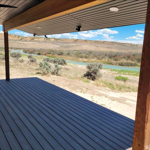 9381 South Sevier Riv Ranch Levan, UT 84639 - Photo 5 of 58 Expansive outdoor deck with dark wood-finish planking, supported by a substantial wood beam