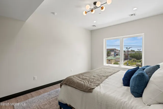 a front view of a building with lot of cars and trees