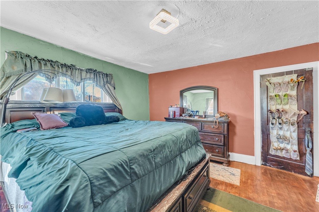 2123 North Taylor Road Cleveland Heights, OH 44112 - Photo 20 of 38 Bedroom with wood finished floors and a textured ceiling