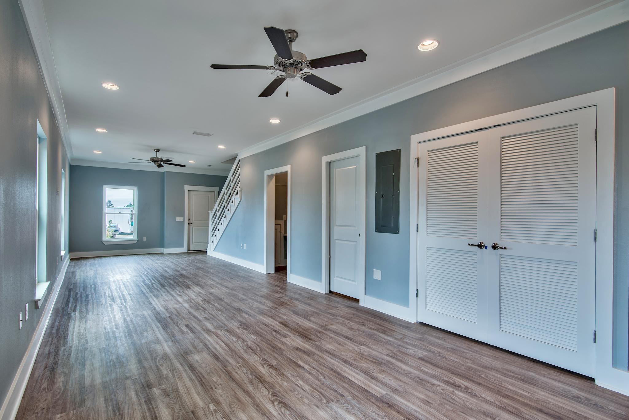 65 South Sand Palm Road, Unit 31 Freeport, FL 32439 - Photo 7 of 24 a view of an empty room with wooden floor and a ceiling fan
