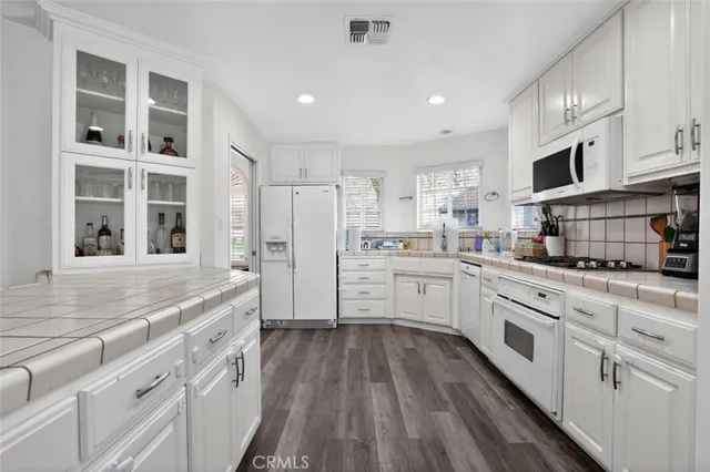 a kitchen with stainless steel appliances a refrigerator sink and cabinets