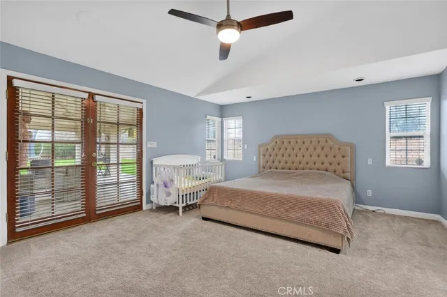 a spacious bedroom with a bed and a large window