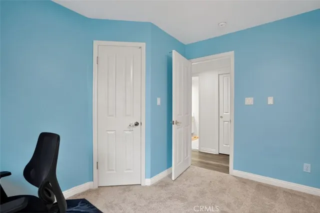 a view of a room with furniture and wooden floor