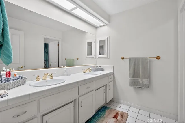 a bathroom with a double vanity sink mirror and