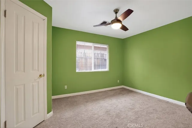 a view of room with window and ceiling fan