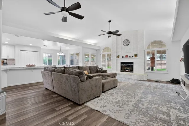 a living room with furniture a fireplace and a chandelier