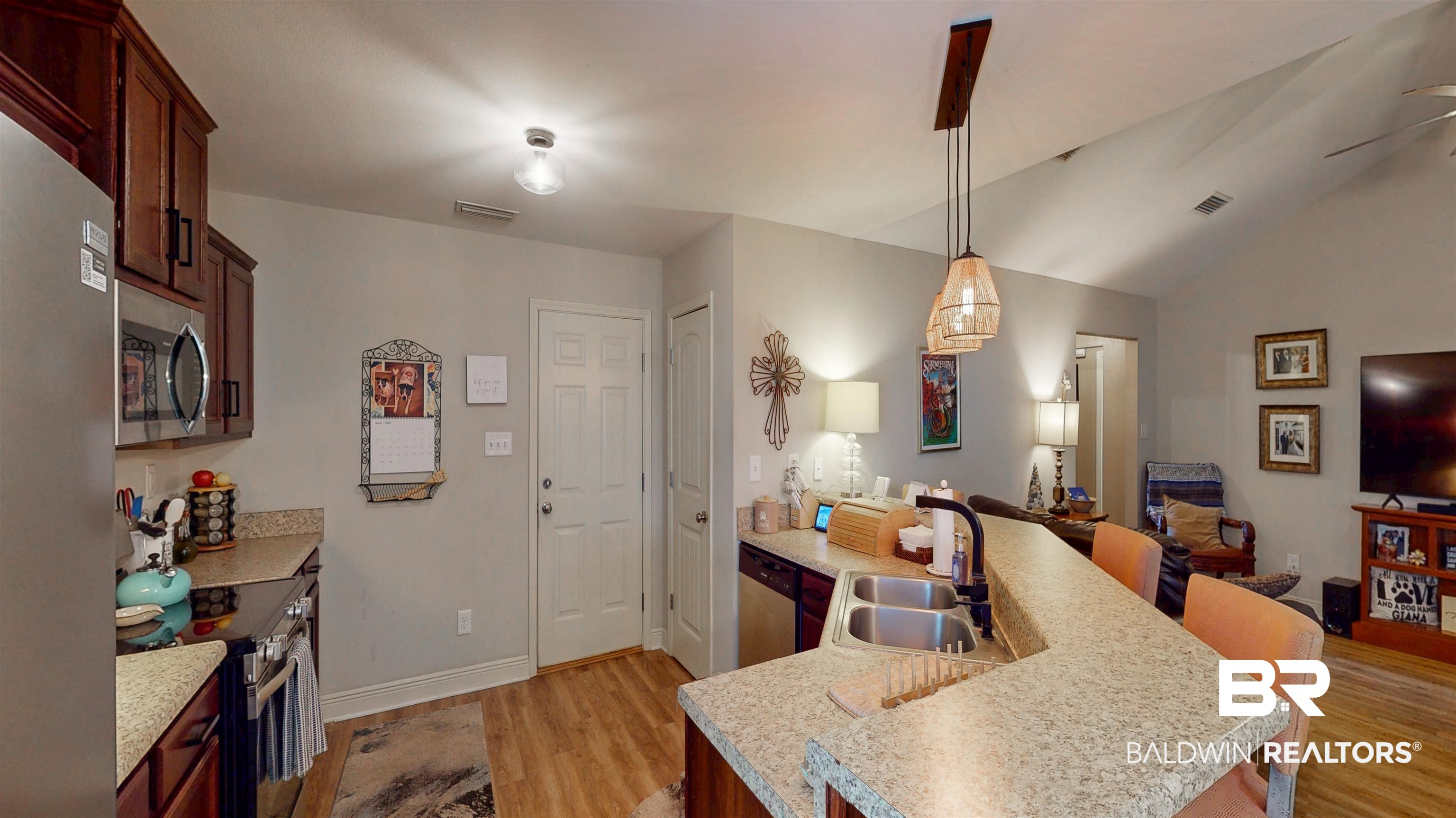 1304 Majesty Loop Foley, AL 36535 - Photo 8 of 44 Kitchen featuring a kitchen breakfast bar, stainless steel appliances, light wood-style flooring, light countertops, and vaulted ceiling
