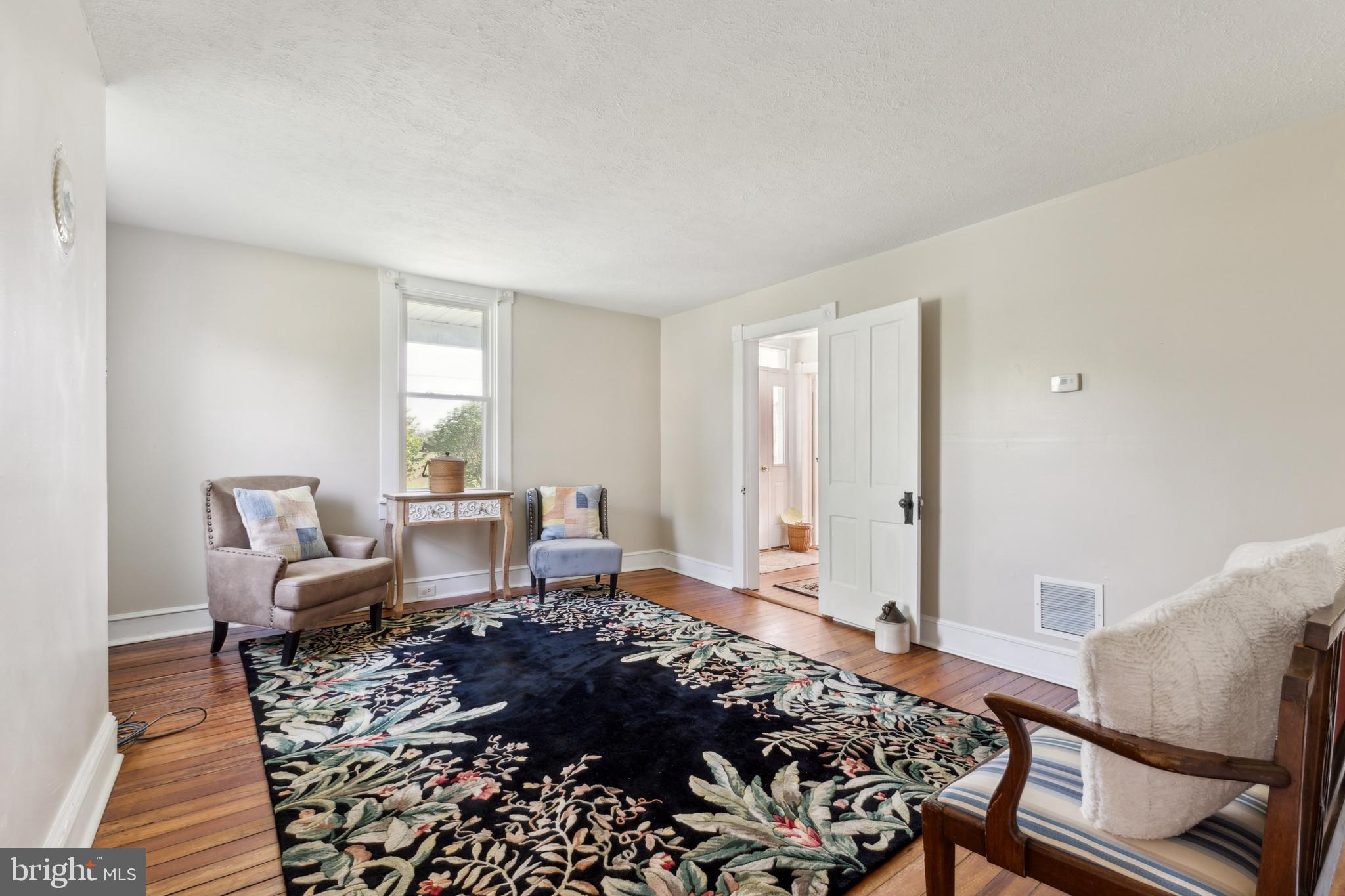 1095 Senseny Road Berryville, VA 22611 - Photo 17 of 47 a living room with furniture wooden floor and a window