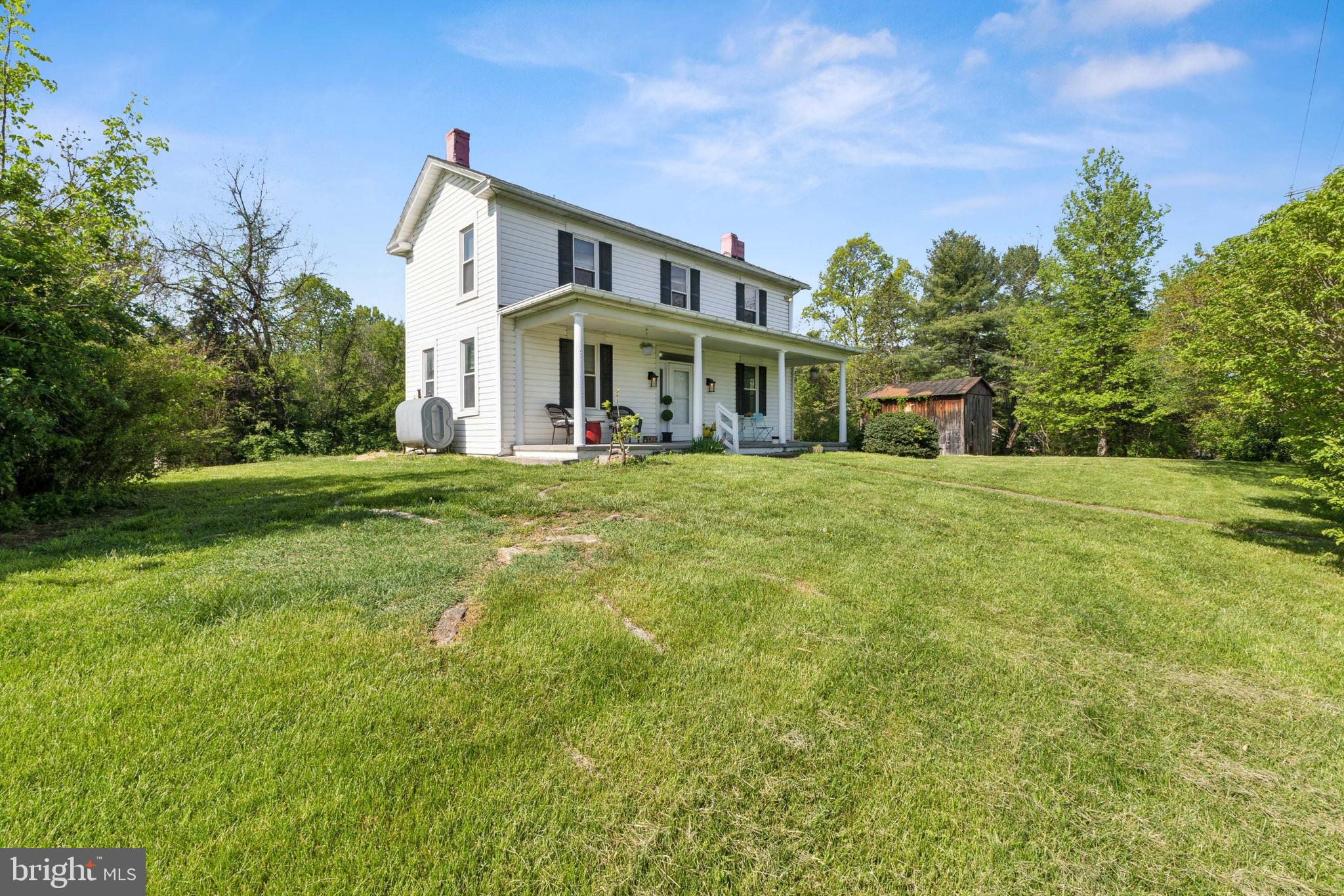 1095 Senseny Road Berryville, VA 22611 - Photo 44 of 47 a view of a white house with a big yard and large trees