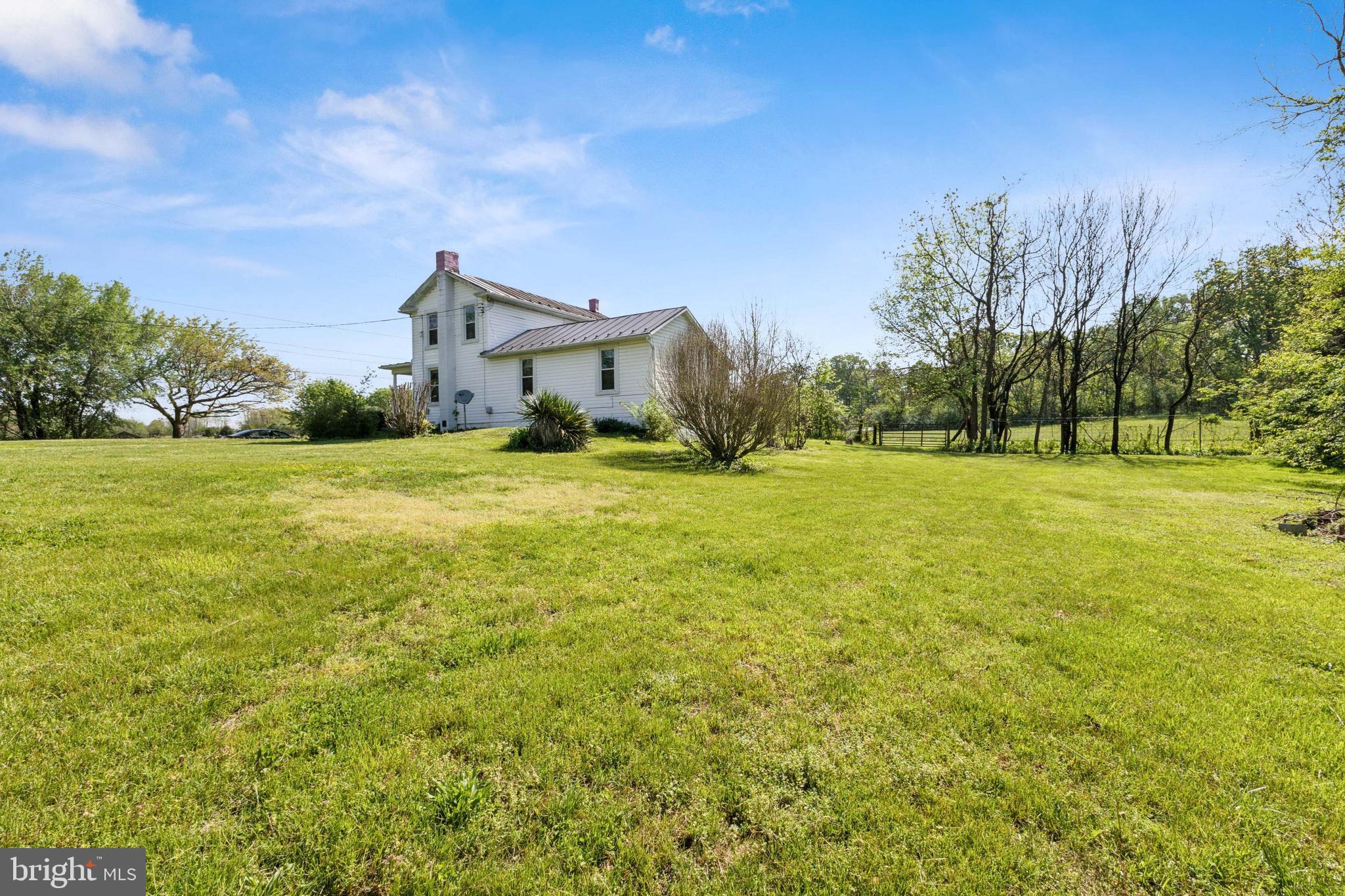 1095 Senseny Road Berryville, VA 22611 - Photo 46 of 47 a view of a big yard with a house in the background