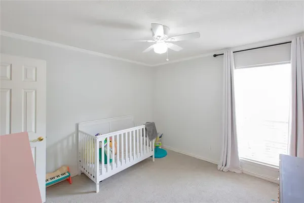 a view of a room with a window and ceiling fan