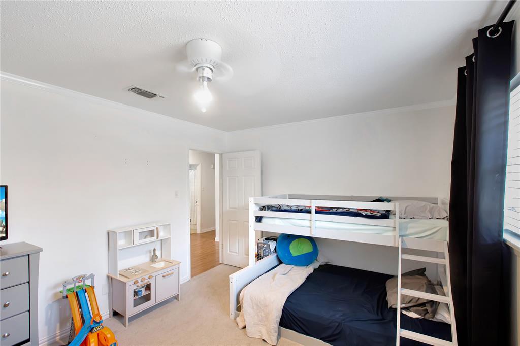 853 Royal Terrace Hurst, TX 76053 - Photo 18 of 34 a room that has a bed and a chair in it