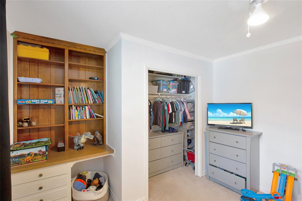 853 Royal Terrace Hurst, TX 76053 - Photo 19 of 34 a view of walk in closet with clothes and shoes